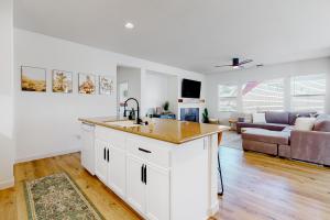 a kitchen and living room with a sink and a couch at Tranquil Desert Sanctuary in Indio