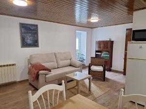 a living room with a couch and a table at Casa María in Baltar +5 photos