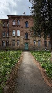 an old brick building with a pathway in front of it at Апартаменти в парку in Uman