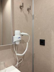a shower with a blow dryer in a bathroom at Hostal Juan Carlos in Carboneras +60 photos