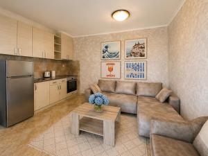 a living room with a couch and a table at Old Sailor`s house Rafailovici in Rafailovici