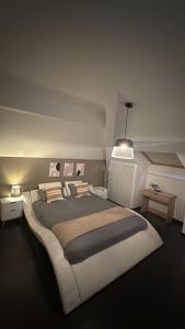 a bedroom with a large bed and a pendant light at Modern Apartment in Annemasse 15 mins to Geneva with private free parking in Vétraz-Monthoux