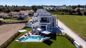 an aerial view of a house with a swimming pool at The Four Villas Hanioti by Luxlikehome in Hanioti