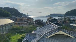 an overhead view of a city with houses and the water at 楽校うらしり in Uwajima +7 photos