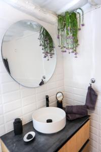 a bathroom with a sink and a mirror at Plomari Nest in Plomari