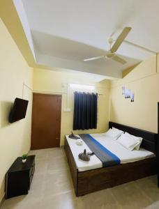 a bedroom with a bed and a ceiling at The Pinnacle Stays in Guwahati