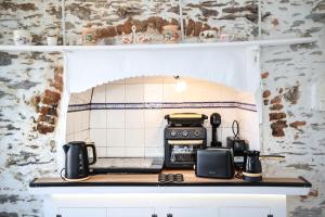 a small kitchen with a stove top oven at Plomari Nest in Plomari +22 photos