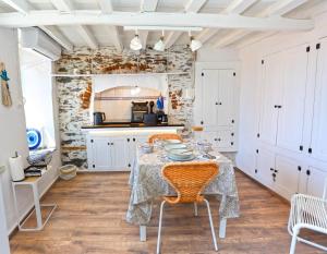 a kitchen with a table and chairs in a room at Plomari Nest in Plomari