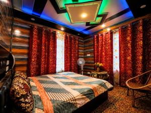a bedroom with a bed and curtains in a room at Water Vibe Homestay Srinagar in Srinagar