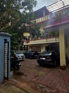 a group of cars parked in front of a building at The Pinnacle Stays in Guwahati