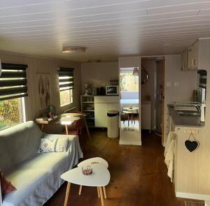 a living room and kitchen with a couch and a table at La Casetta in Gattières