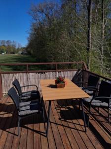 a wooden table and chairs on a deck at Holiday Nest 1 in Sønderborg