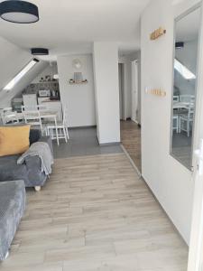 a living room with a couch and a table at Dömper Döme Apartman in Balatonlelle