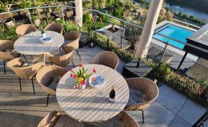 two tables and chairs with flowers on a patio at Villa Orange Tree in Bernkastel-Kues