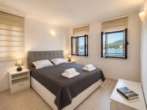 a bedroom with a bed with two towels on it at Old Sailor`s house Rafailovici in Rafailovici