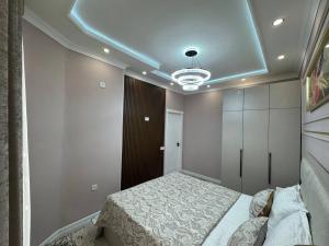 a bedroom with a bed and a blue ceiling at Runa modern flat in Samarkand