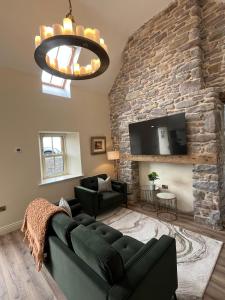 a living room with a couch and a stone wall at Kittys Haven in Castlemaine