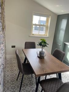 a dining room with a wooden table and chairs at Kittys Haven in Castlemaine