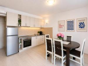 a kitchen and dining room with a table and a refrigerator at Old Sailor`s house Rafailovici in Rafailovici +10 photos