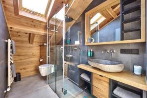 a bathroom with a sink and a glass shower at Ferienhaus Magdalena in Mittenwald +28 photos