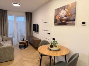 a living room with a table and a couch at Pajūrio Namai in Palanga