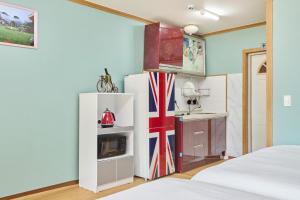 a kitchen with a refrigerator and a sink in a room at Heidi Korea in Hongcheon