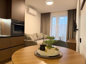 a kitchen and a living room with a table at Pajūrio Namai in Palanga