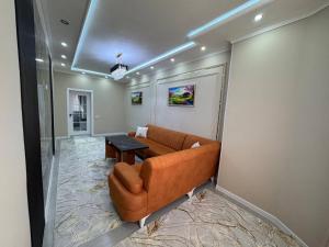 a living room with a couch and a table at Runa modern flat in Samarkand