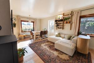 a living room with a couch and a table at Tiny House - The LOWFO House Lofoten in Moskenes