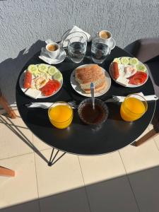 a black table with plates of food on it at Hotel Shkodra Comfort in Shkodër