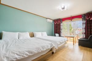 a bedroom with a large bed and a window at Heidi Korea in Hongcheon +106 photos