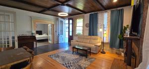 a living room with a couch and a table at Distinguished Home in Scranton