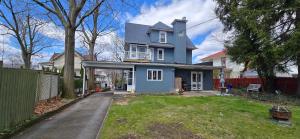a blue house with a fence and a yard at Distinguished Home in Scranton