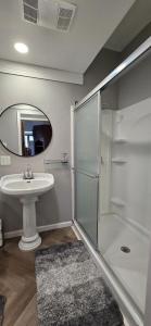 a bathroom with a shower and a sink at Distinguished Home in Scranton +25 photos