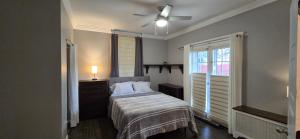 a bedroom with a bed and a ceiling fan at Distinguished Home in Scranton