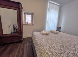 a bedroom with a bed with two towels on it at Casa di in Ascoli Piceno