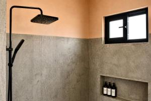 a shower in a bathroom with a window at Simple Stay, Big Views, Private Room & Pool in Todos Santos