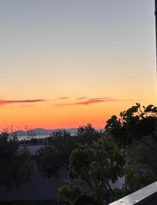a sunset from the balcony of a house at MARIS MOBILE HOME in Drage