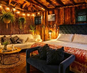 a bedroom with a bed and a couch and a table at Sunset Calm Retreat Bungalow in Haleiwa