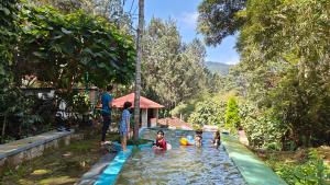 a group of people playing in a water park at Enchanting woods Yercaud in Yercaud