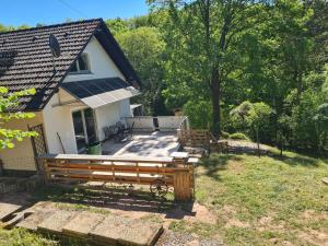 a house with a large deck in the yard at Luessishausen im Lüsserttal mit 140m2 und DSL in Feilbingert