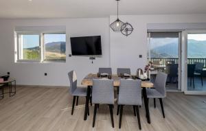 a dining room with a table and chairs at Beautiful Home In Vrgorac in Vrgorac