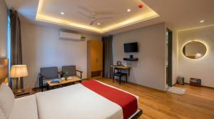 a hotel room with a bed and a tv at Yashobhoomi Hotel Grand Tashree in New Delhi