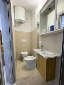 a bathroom with a toilet and a sink and a mirror at La casina di Sara in Cavo