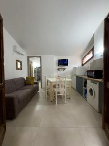 a living room with a couch and a table at La casina di Sara in Cavo +13 photos