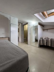 a bedroom with a bed and a bathroom at La casina di Sara in Cavo
