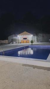 a swimming pool in a yard at night at tsilo in Batumi