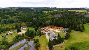 an aerial view of a resort with a lake at Růžená - chatky u rybníka in Milevsko