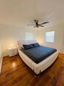 a large bed in a room with a ceiling fan at Lion House in Bentonville