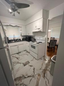 a kitchen with white cabinets and a stove at Lion House in Bentonville +10 photos